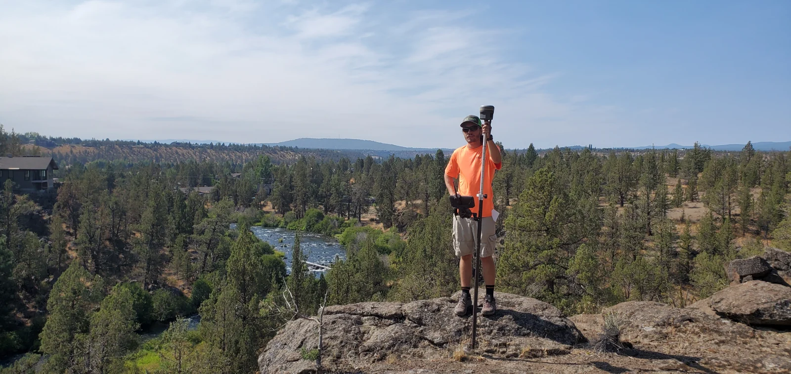 Povey surveyor taking GPS measurements above a Central Oregon river